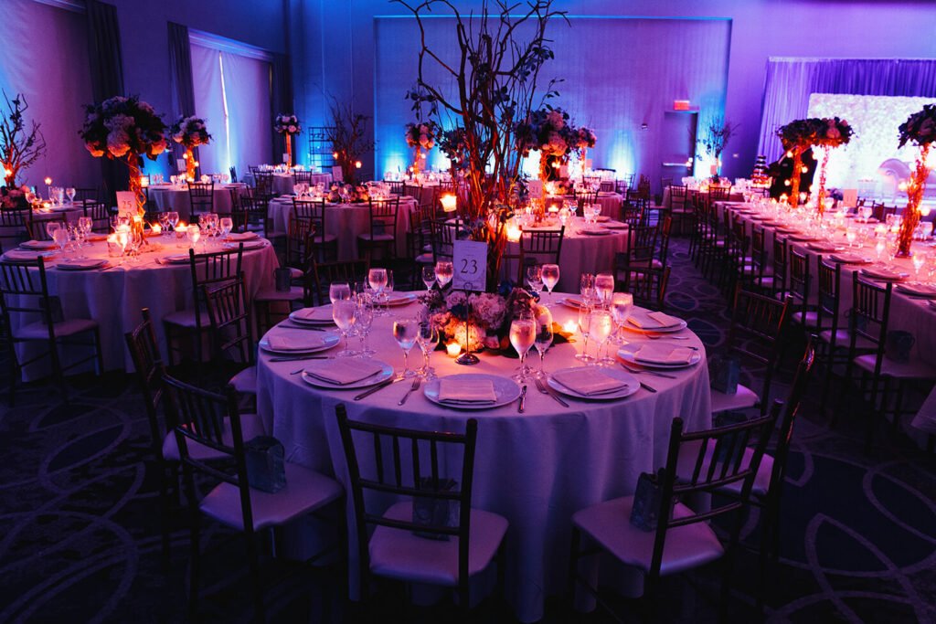 decorated wedding hall with candles round tables centerpieces (1)
